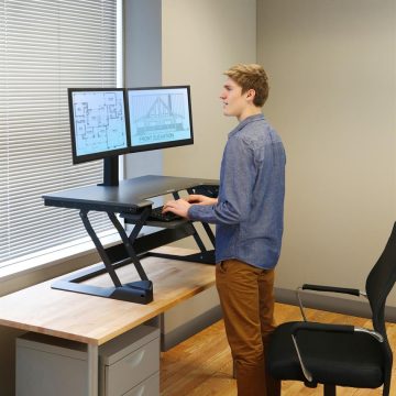 Man using ergonomic standing desk